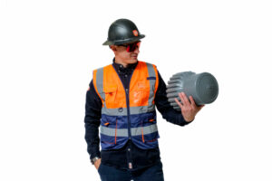An ERG Industrial worker wearing a hard hat, safety glasses and high-visibility vest, holding a varistem stemming plug